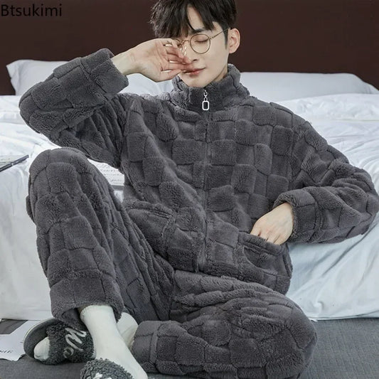Person wearing a gray quilted onesie sitting on a bed.