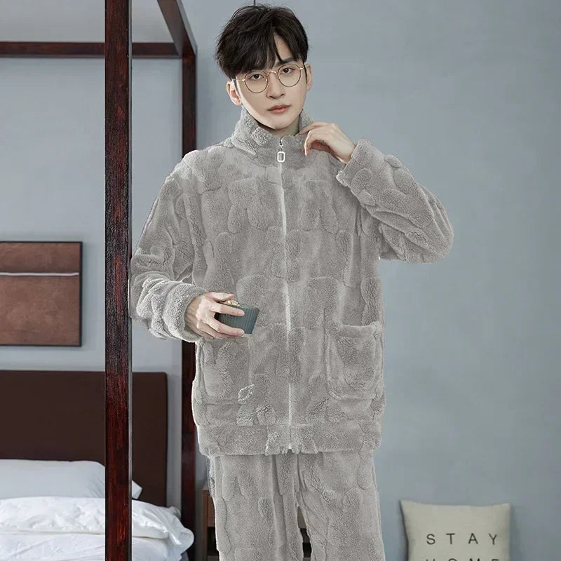 Person wearing a gray textured outfit in a room with a bed and wall decorations.
