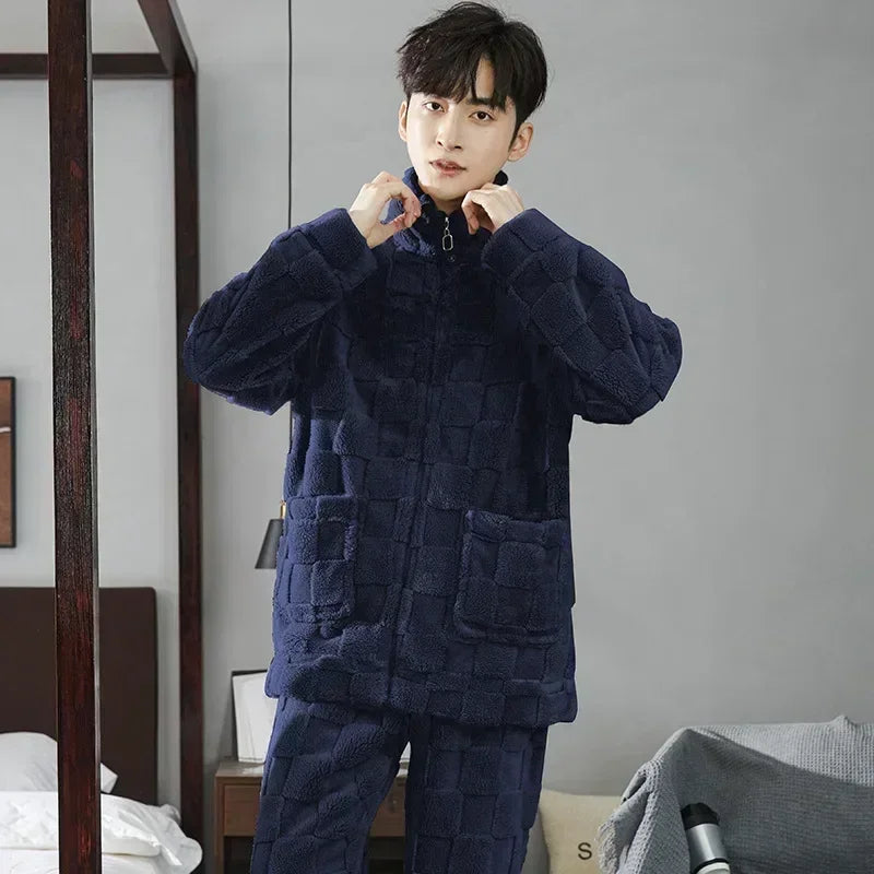 Man wearing a navy blue textured pajama set in a bedroom setting.