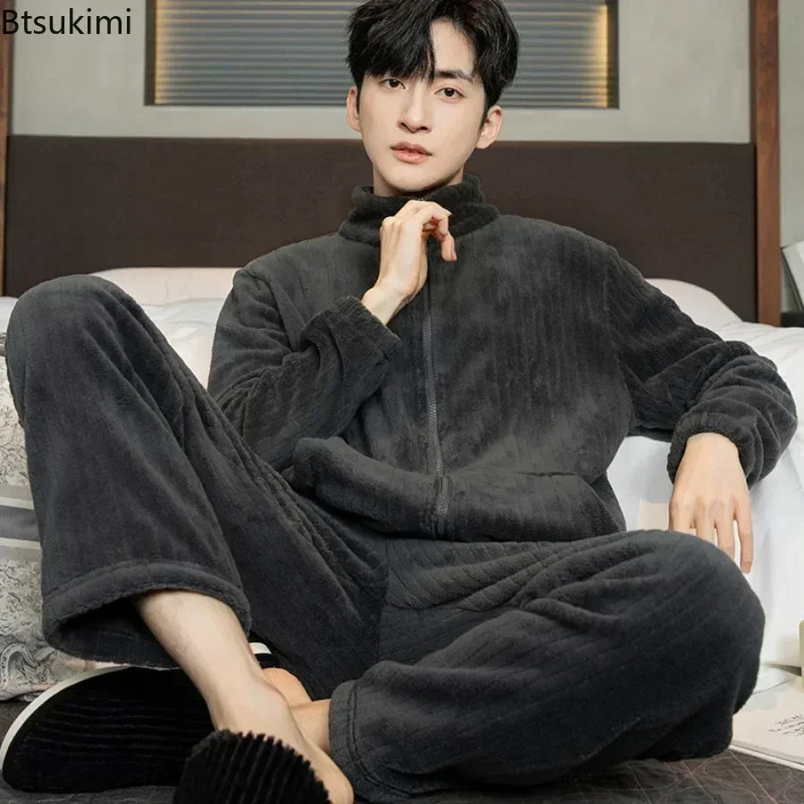 Person wearing a dark gray fleece outfit sitting on a couch.