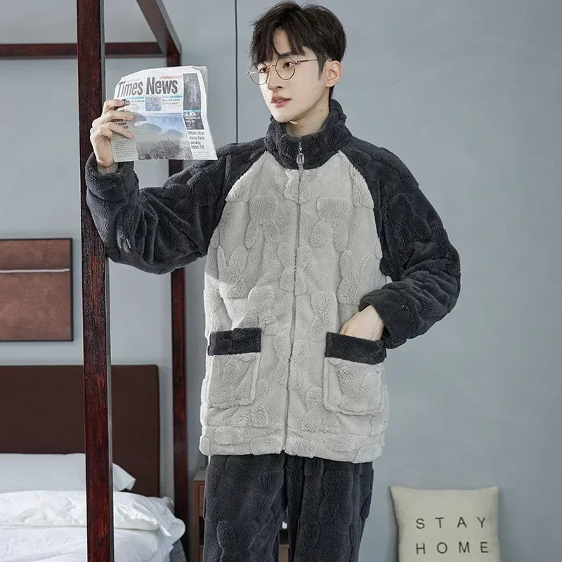 Person wearing a gray and black quilted jacket holding a newspaper indoors.