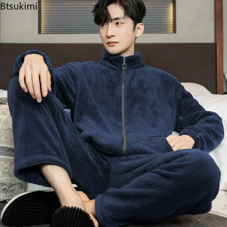 Person wearing a navy blue fleece onesie sitting on a bed.