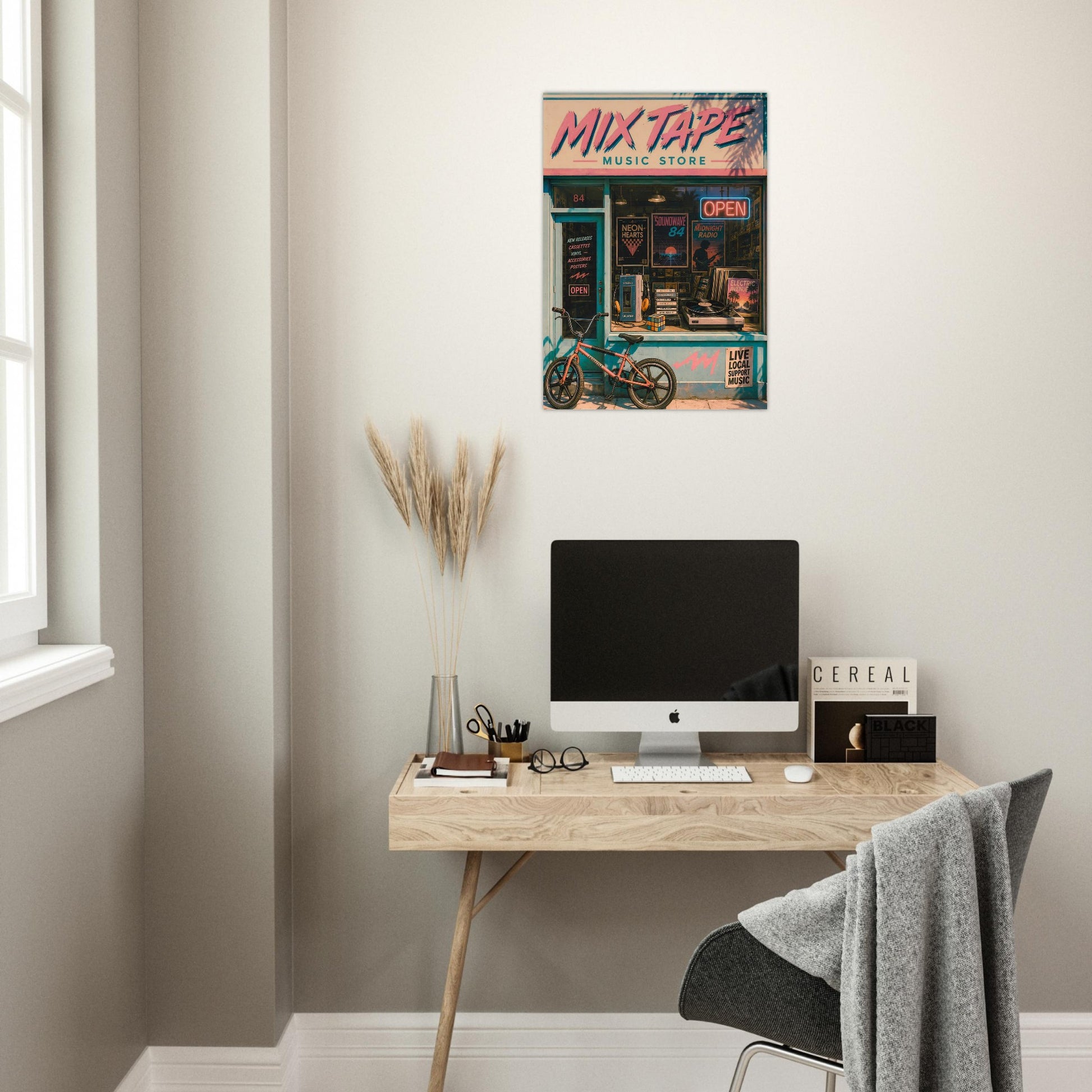 Modern home office with a desk, computer, and decorative poster on the wall of a Mix Tape retro music store 