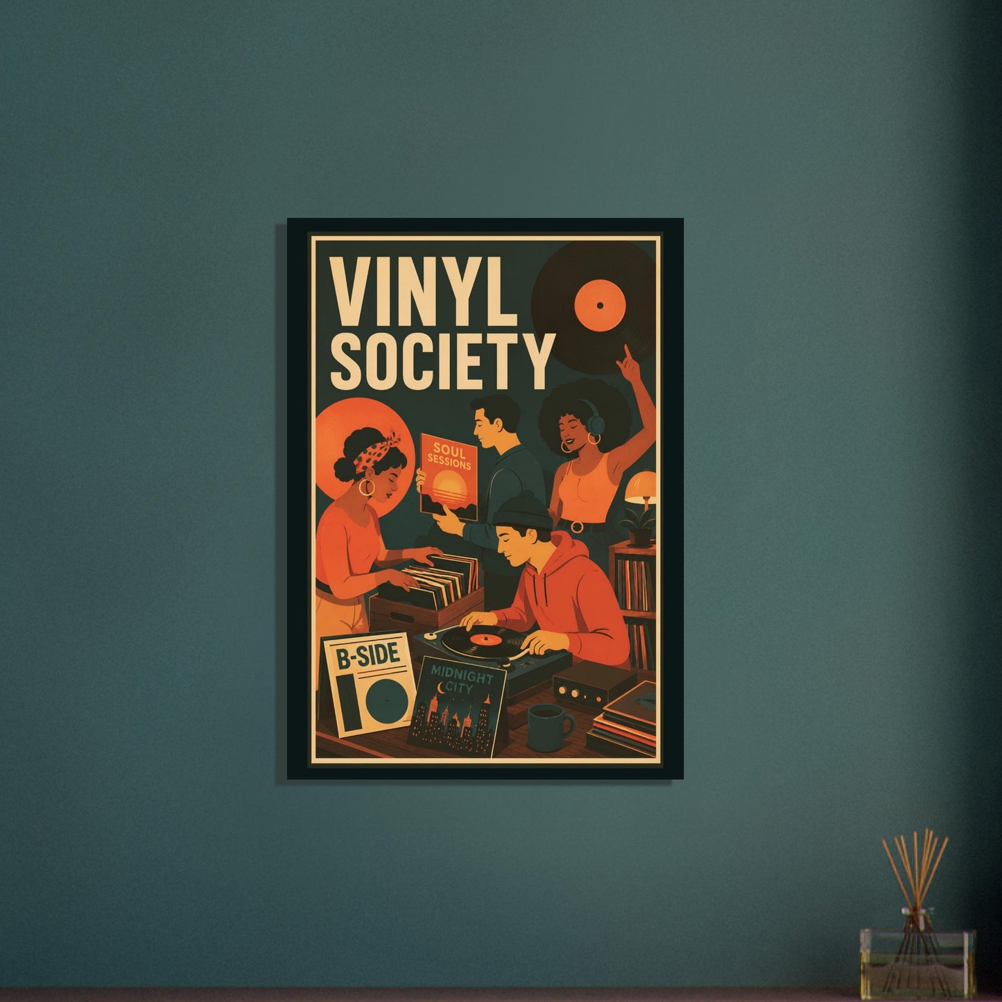 A framed retro-style poster reading 'VINYL SOCIETY' hangs on a dark teal wall above a small tabletop with a reed diffuser. The poster artwork uses warm orange, cream, black, and red tones and depicts people gathered around records.
