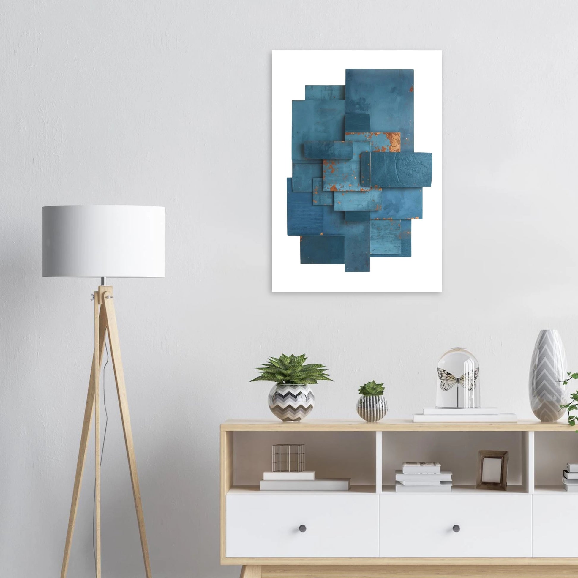 Abstract blue artwork on a wall above a wooden sideboard with decorative items.