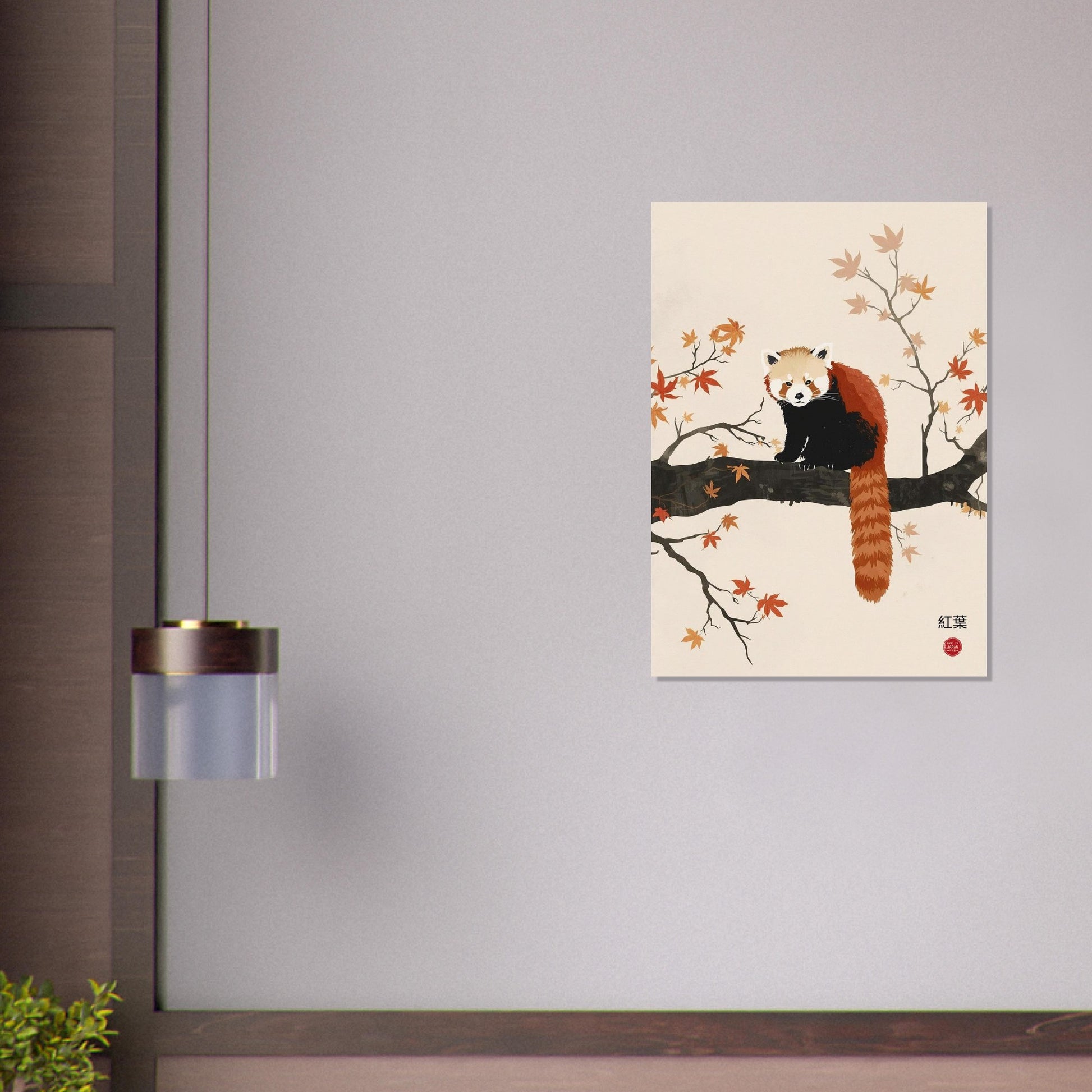 Framed artwork of a red panda on a branch with leaves on a gray wall.