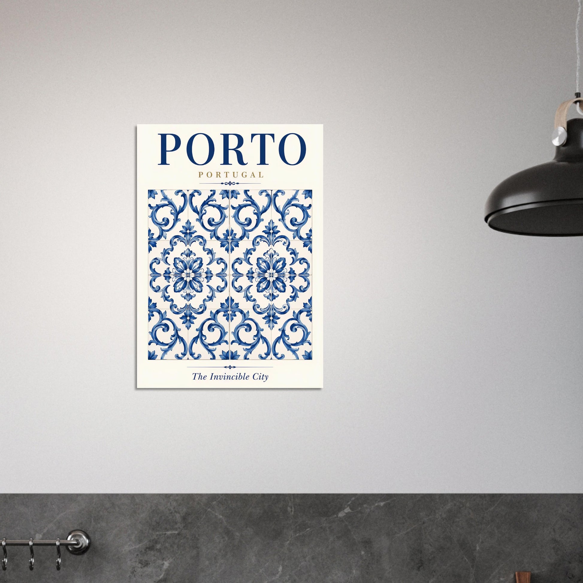 A vertical wall art print featuring a blue and white Portuguese damask pattern with the text 'PORTO' and 'The Invincible City' on a light gray wall, with a black pendant lamp partially visible on the right.