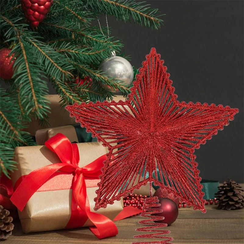 Red star-shaped Christmas tree topper on a decorated Christmas tree with presents.