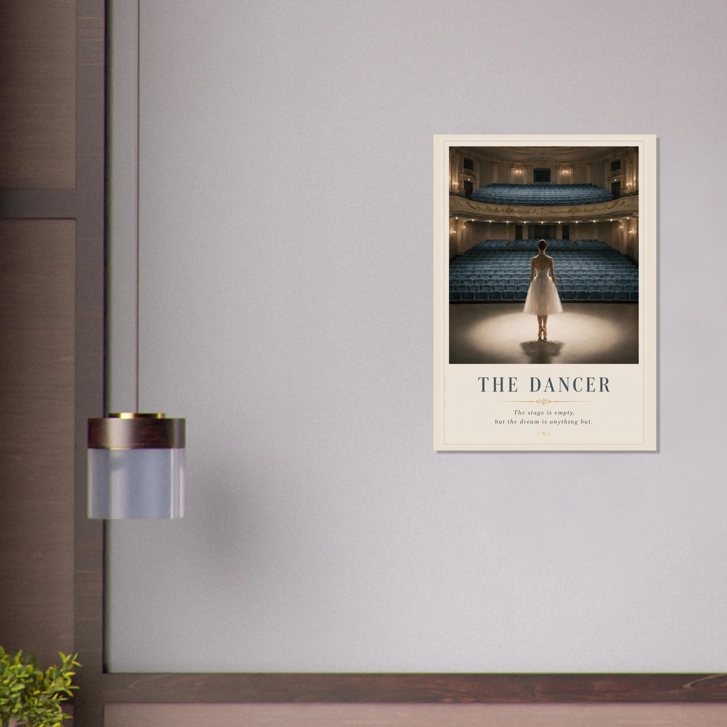 Framed poster of a dancer in an empty theater on a gray wall.