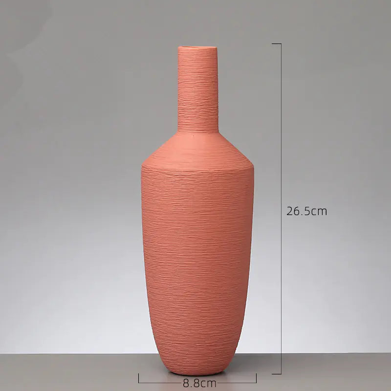 Terracotta-colored vase with measurements on a gray background