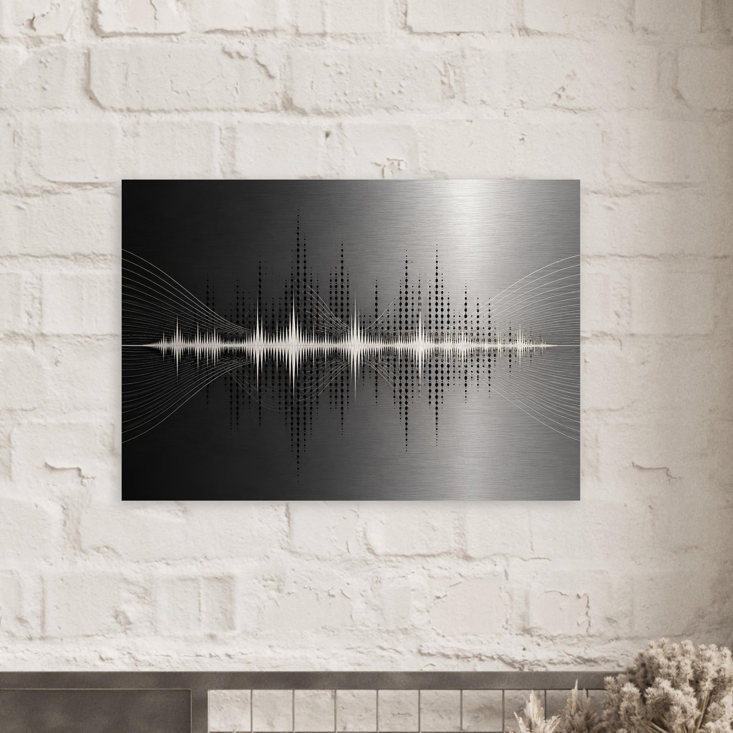 Black and silver soundwave metal print displayed against a white brick wall in a contemporary interior.