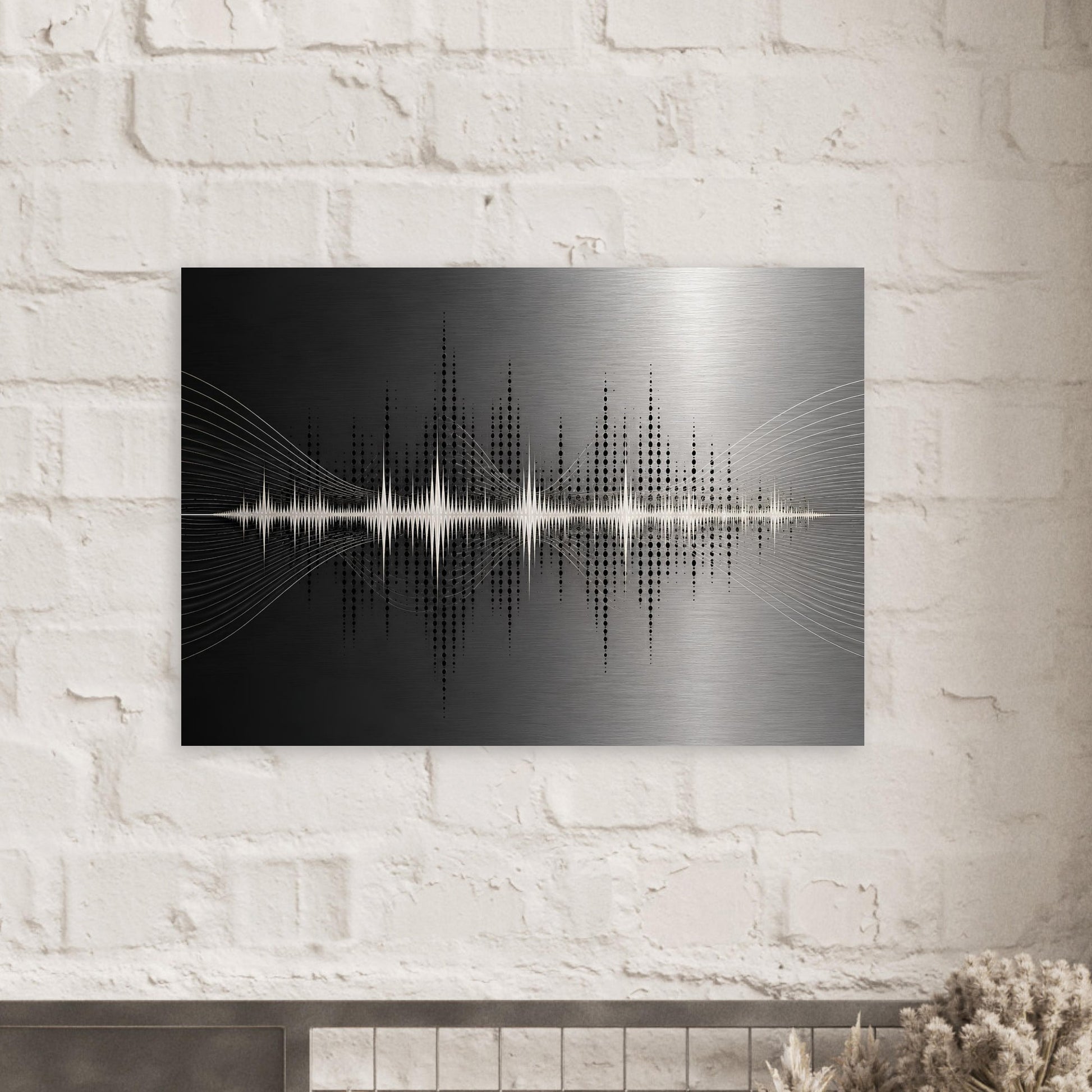 Black and silver soundwave metal print displayed against a white brick wall in a contemporary interior.