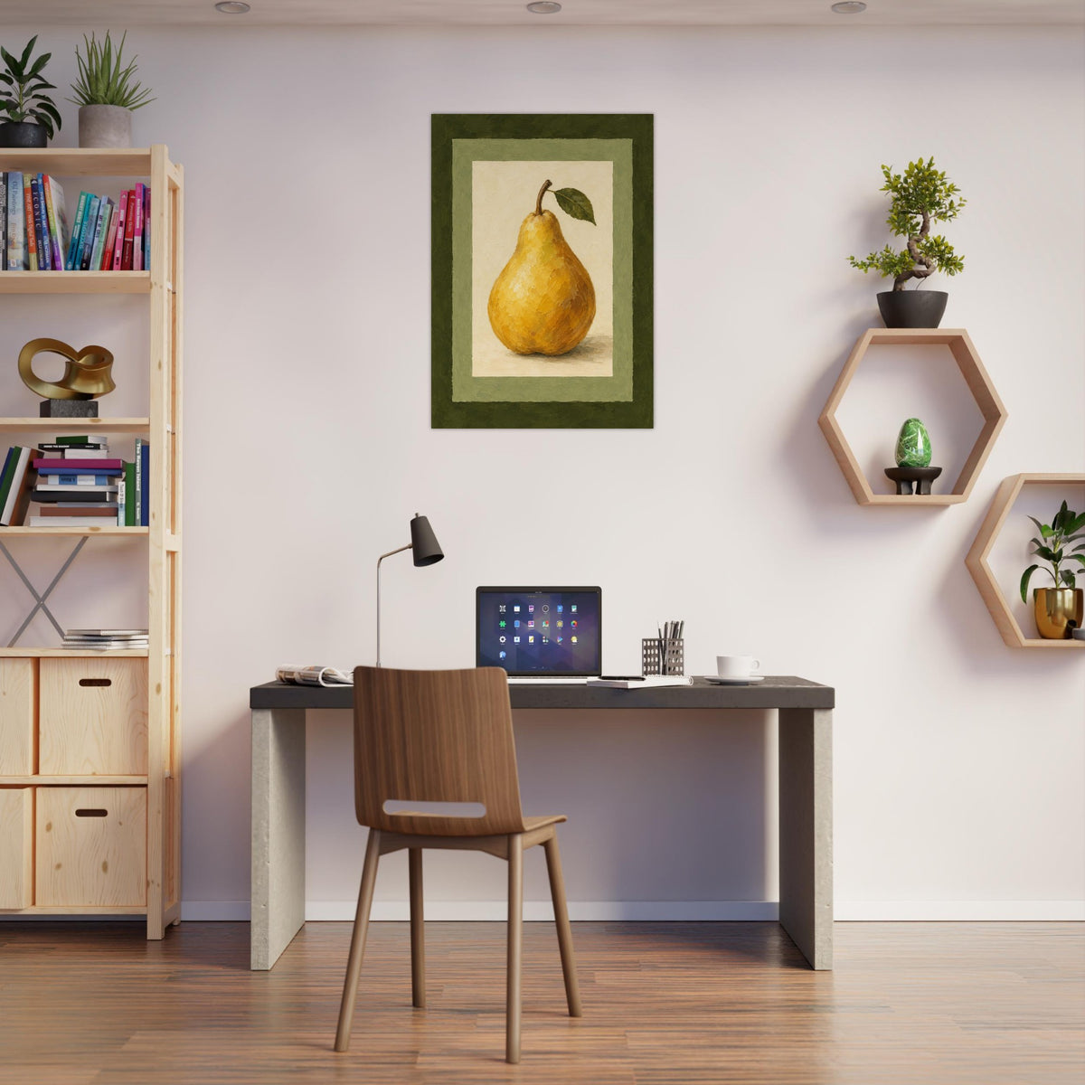 A framed art print of a yellow pear with a green leaf, displayed on a light wall in a modern home office setting above a desk with a chair.