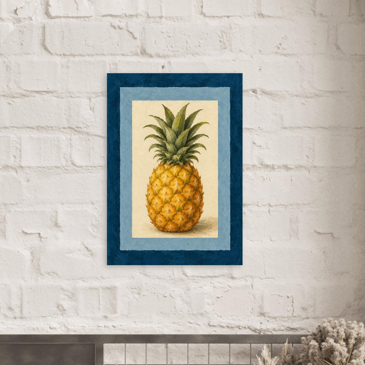 Framed wall art featuring a pineapple illustration, hung on a white brick wall above a mantel with dried flowers.