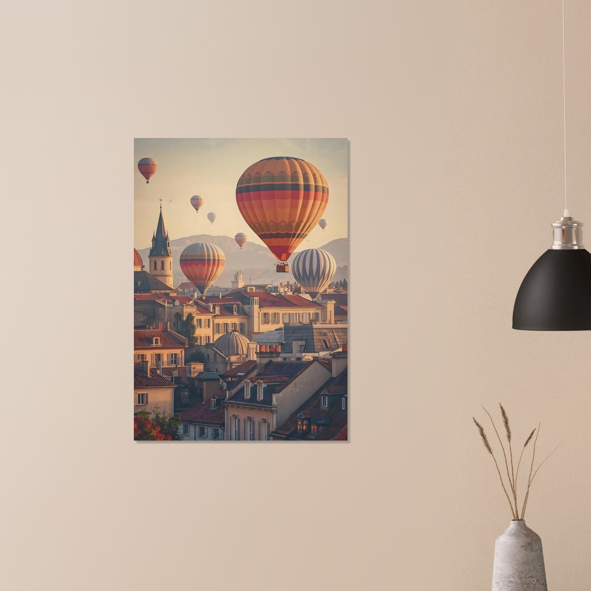 Poster of hot air balloons over a city on a beige wall above a vase with dried plants.