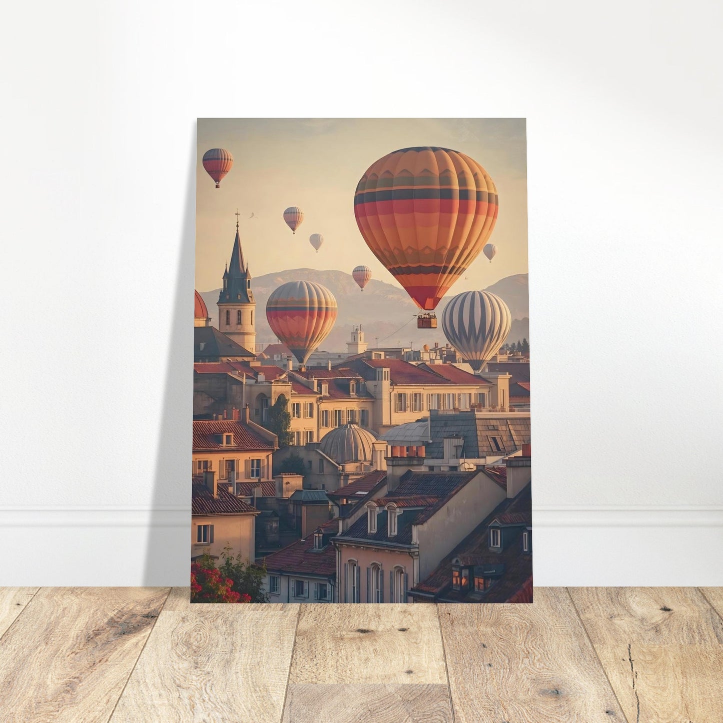 Poster of hot air balloons over a cityscape on a wooden floor with a white wall background