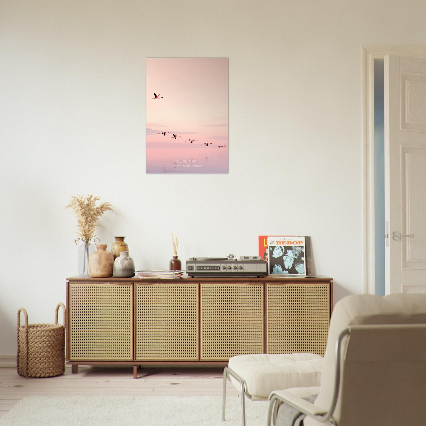 Pink flamingo wall art displayed in a contemporary living room, featuring a flock of birds flying across a tranquil pastel horizon.