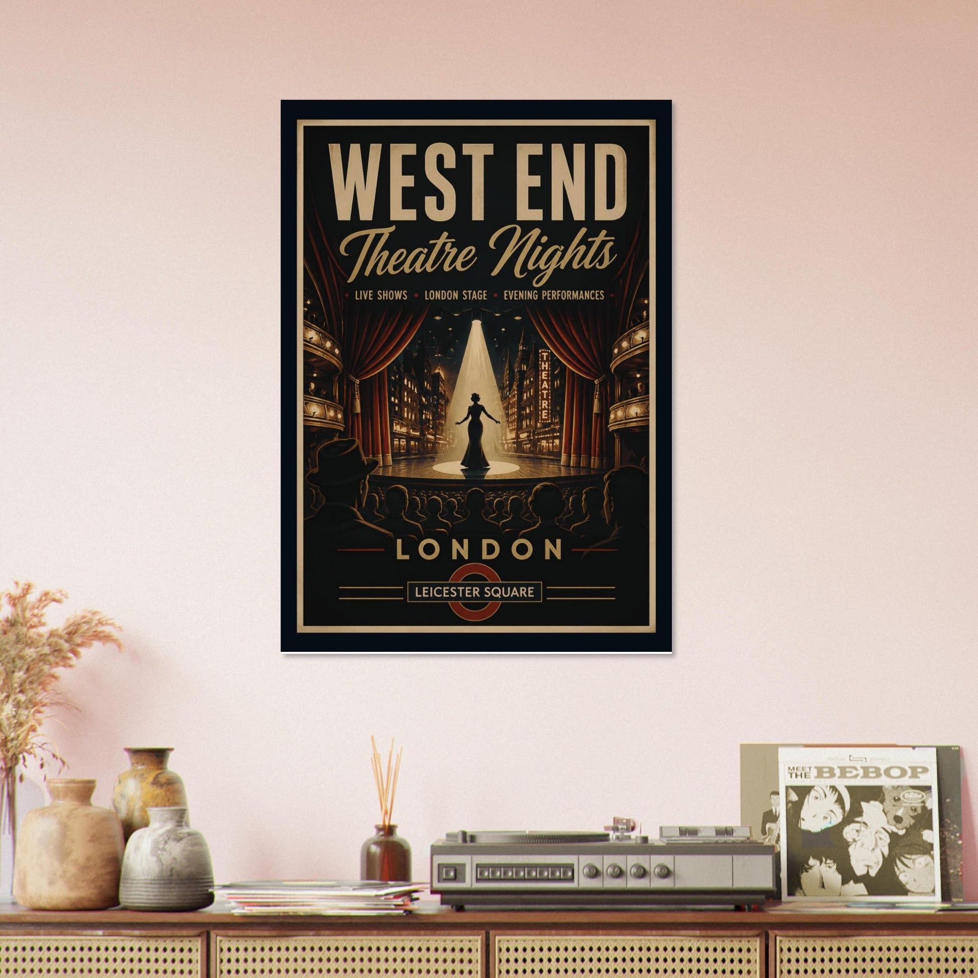 Framed poster advertising 'West End Theatre Nights' in London on a wall above a wooden shelf with decorative items.