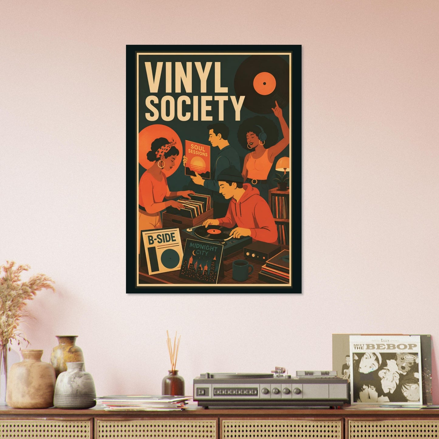 A framed retro-style poster reading 'VINYL SOCIETY' hangs on a pale pink wall above a console table with decorative vases, a record player, and a vinyl record sleeve.