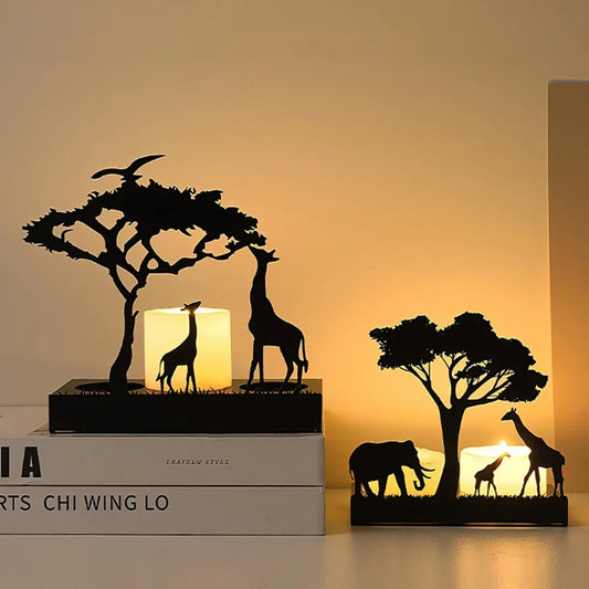2 Decorative candle holders with a giraffe , elephant and tree design on a textured wall background