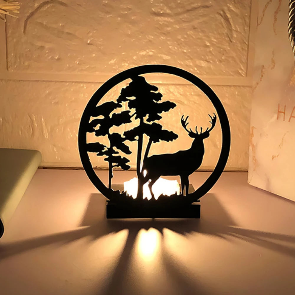 Decorative candle holder with deer and tree design on a neutral background