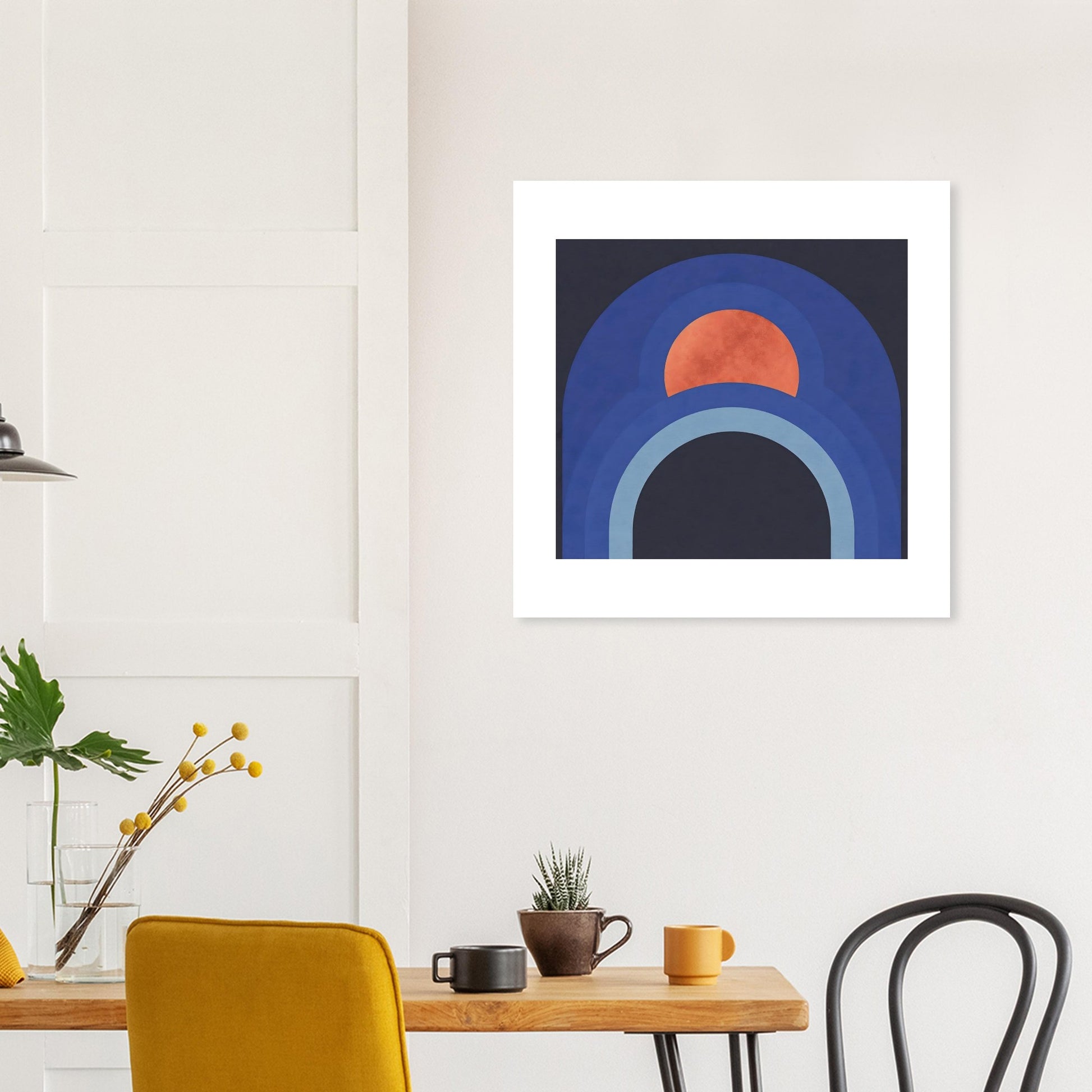 Modern geometric blue arch wall decor styled above mustard chair