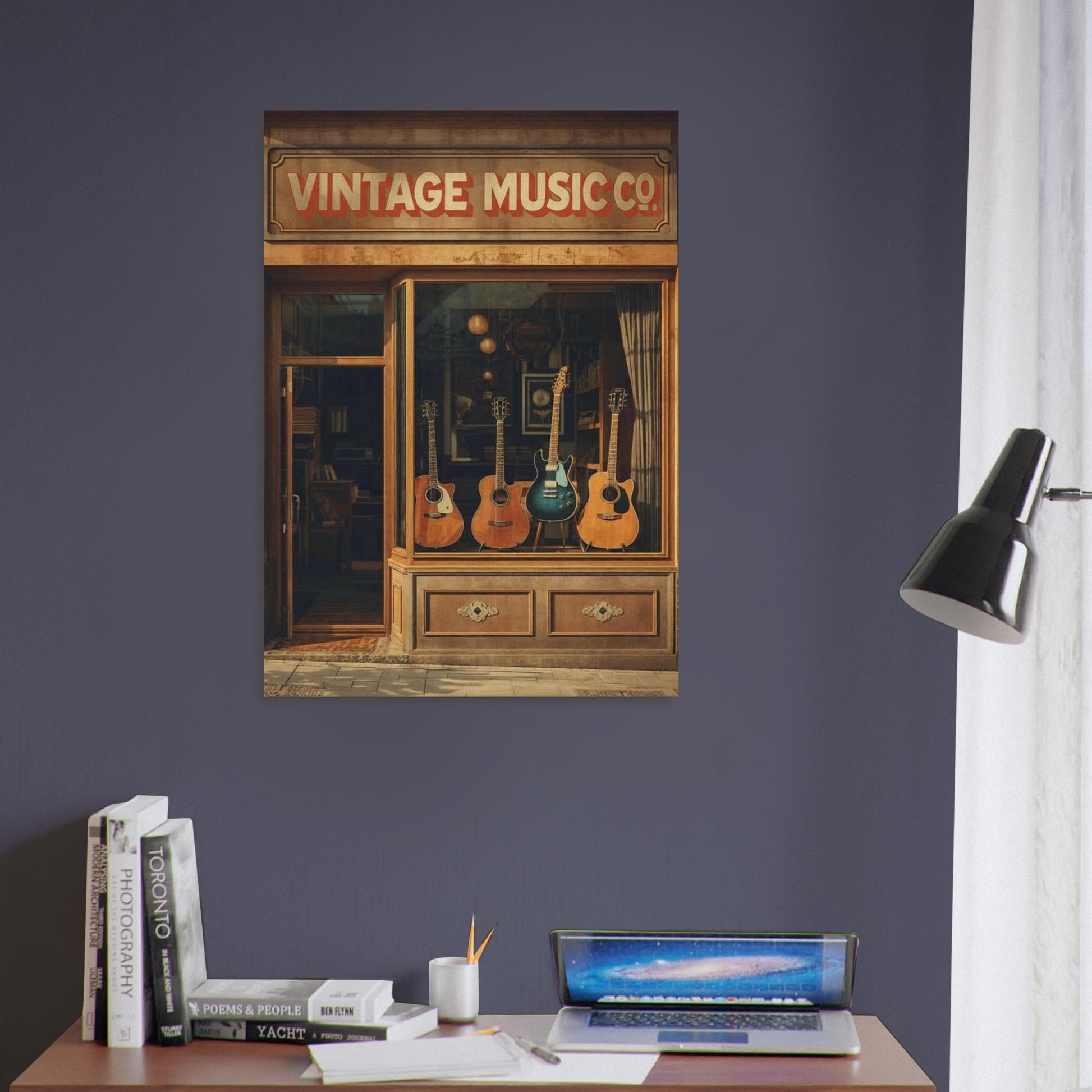 Framed artwork of a vintage music store with guitars on a dark purple wall above a desk.