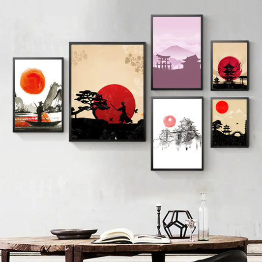 Set of framed artworks on a wall with a wooden table in the foreground.