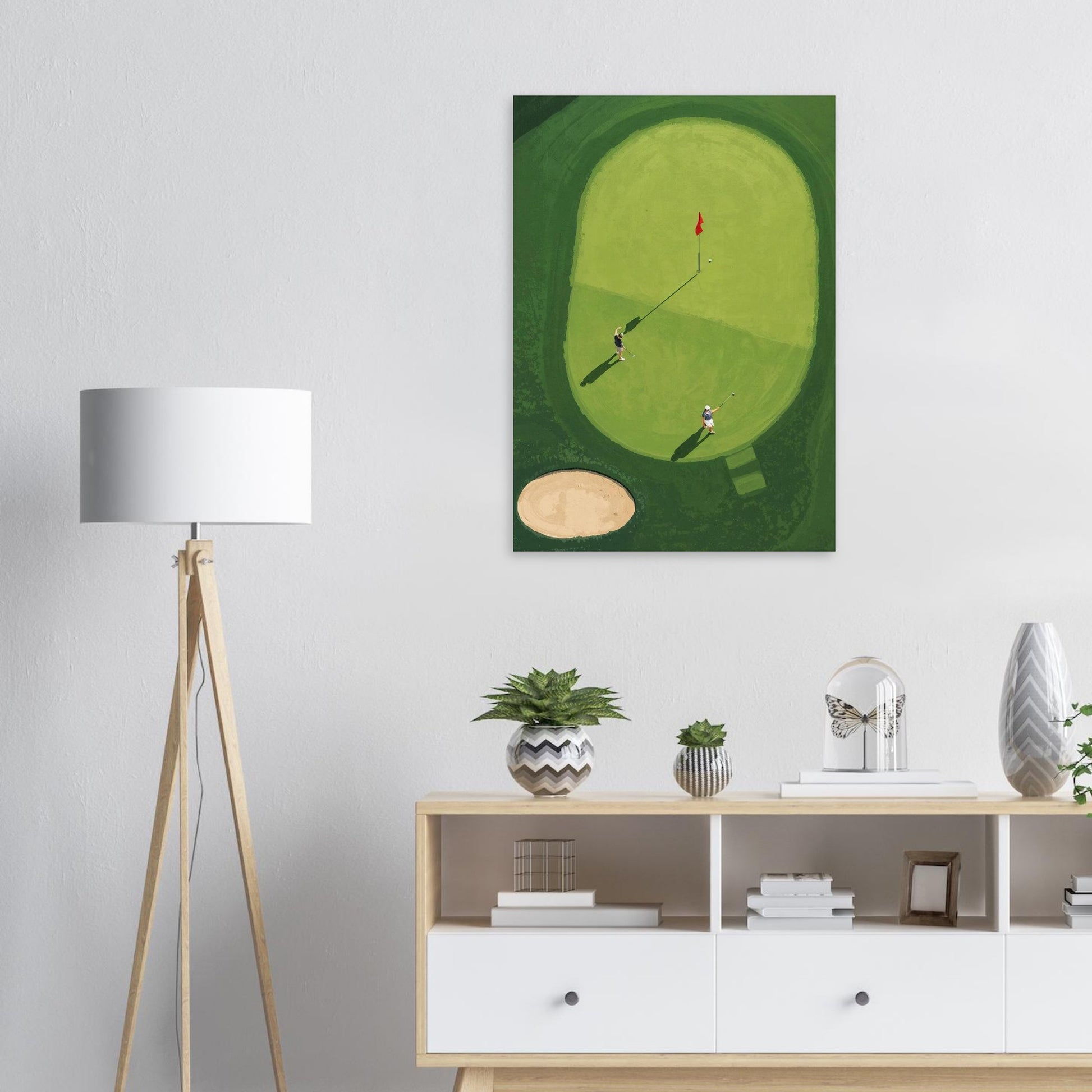 minimalist golf wall art on a wall above a wooden cabinet with decorative items.