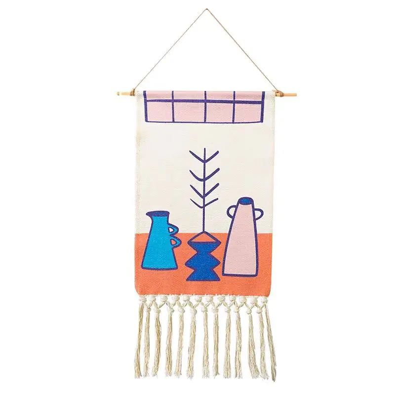 Decorative wall hanging with abstract designs and fringes on a white background