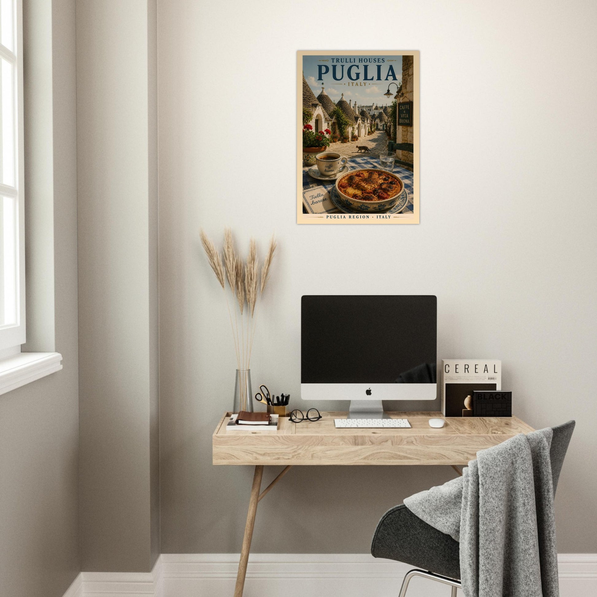 Puglia Italy poster displayed above a desk in a bright minimalist home office