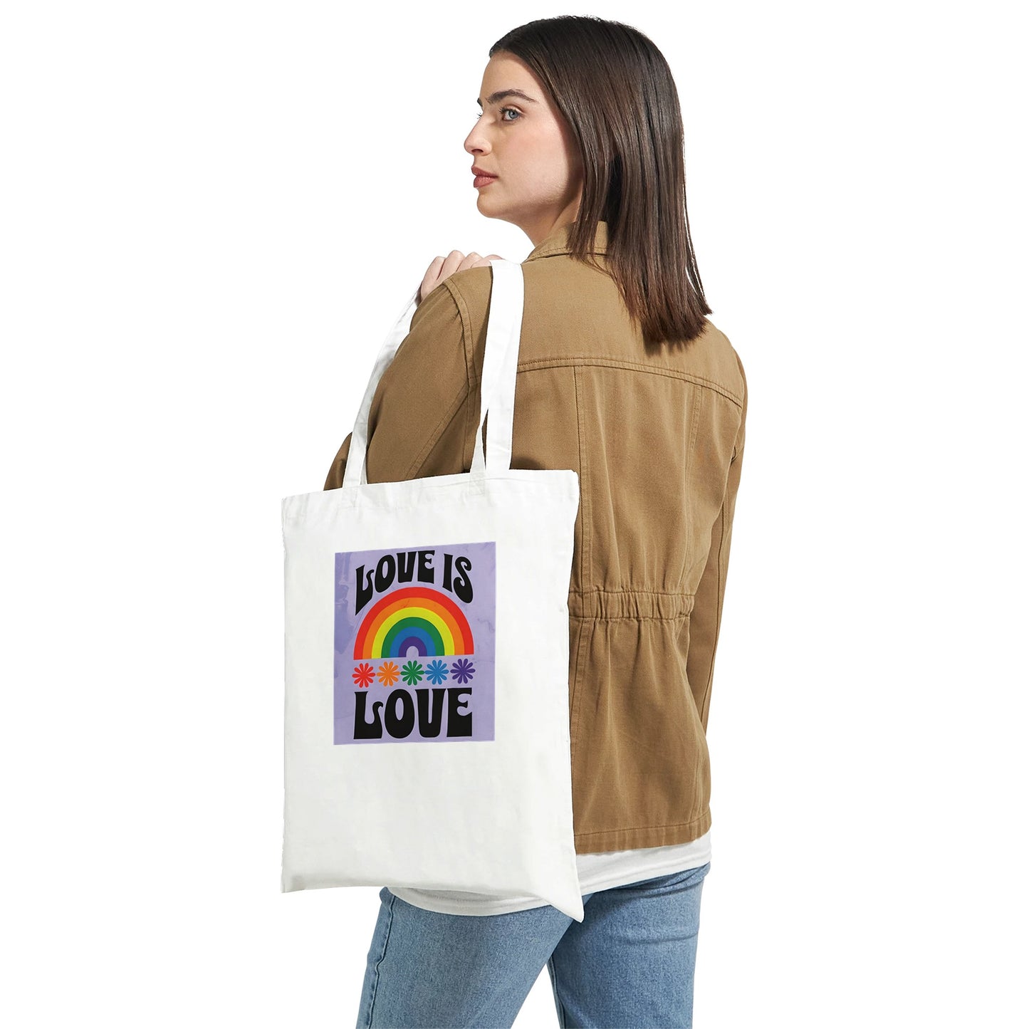 Person holding a tote bag with 'Love is Love' design