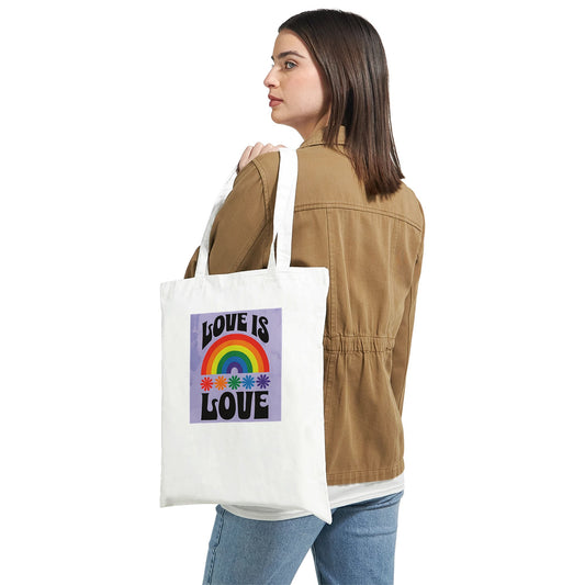 Person holding a tote bag with 'Love is Love' design