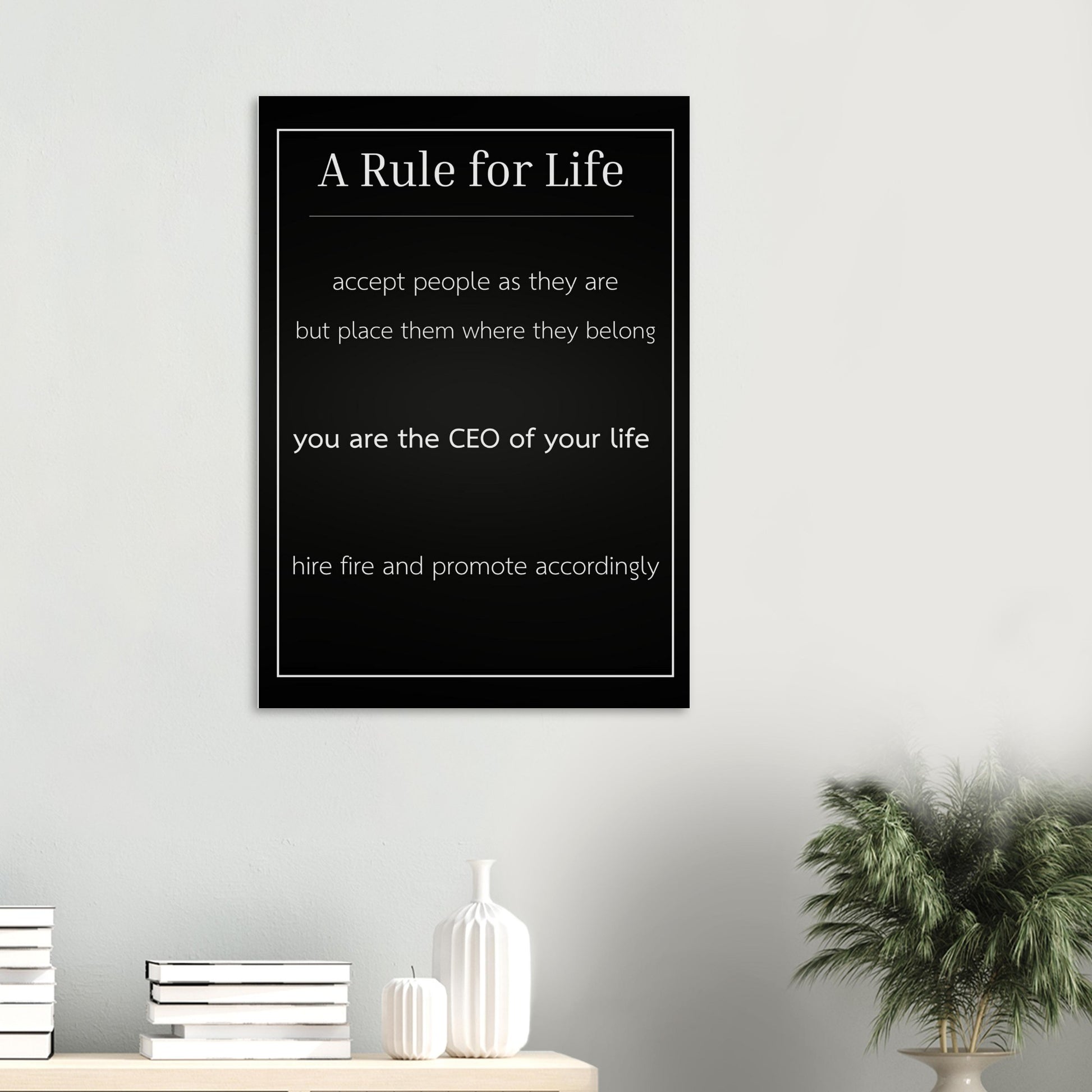 Framed motivational quote on a wall with decor items below