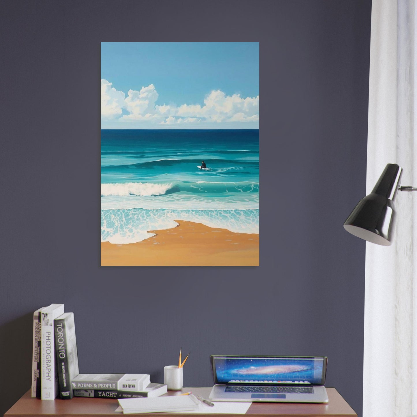 Beach scene painting on a wall above a desk with books and a laptop.