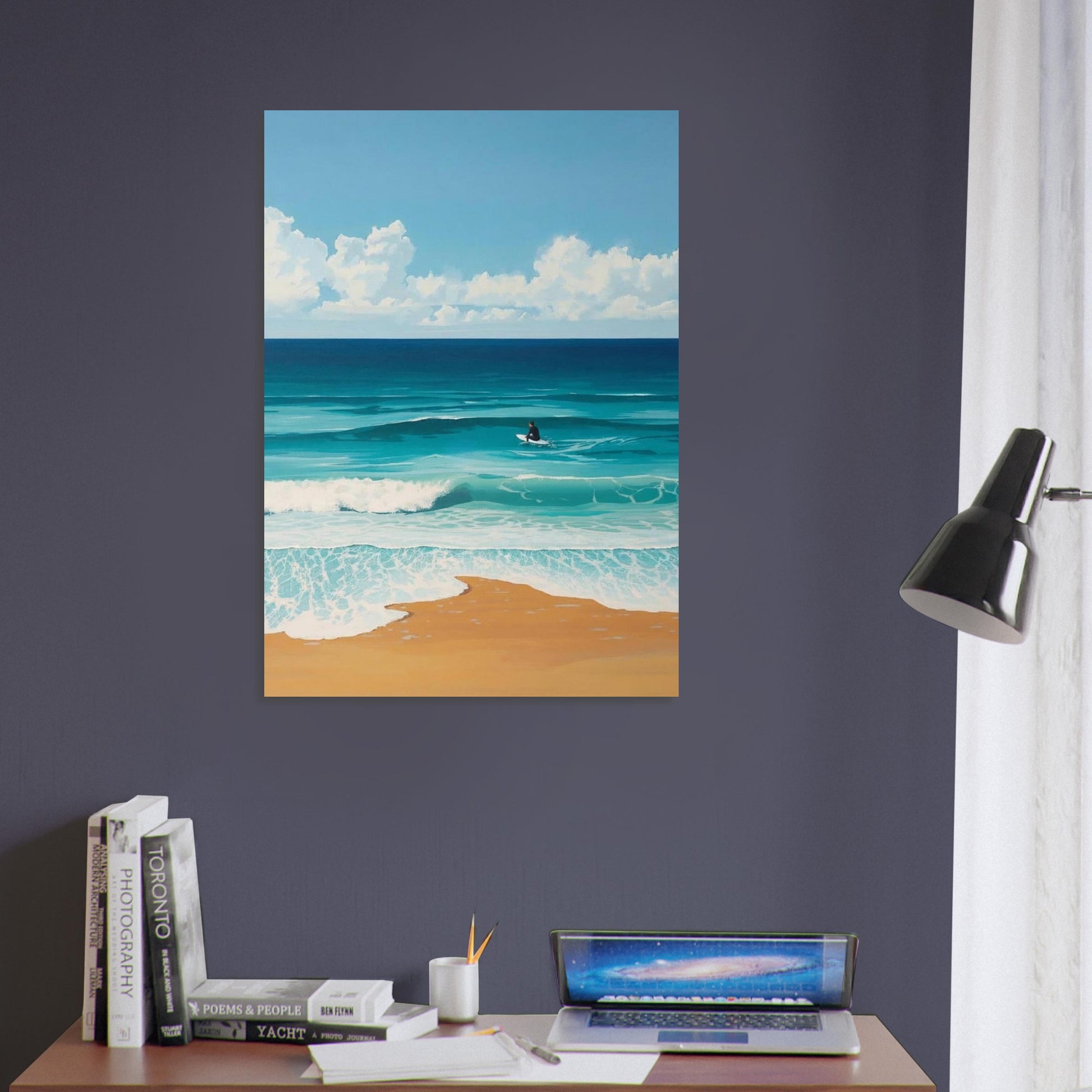 Beach scene painting on a wall above a desk with books and a laptop.