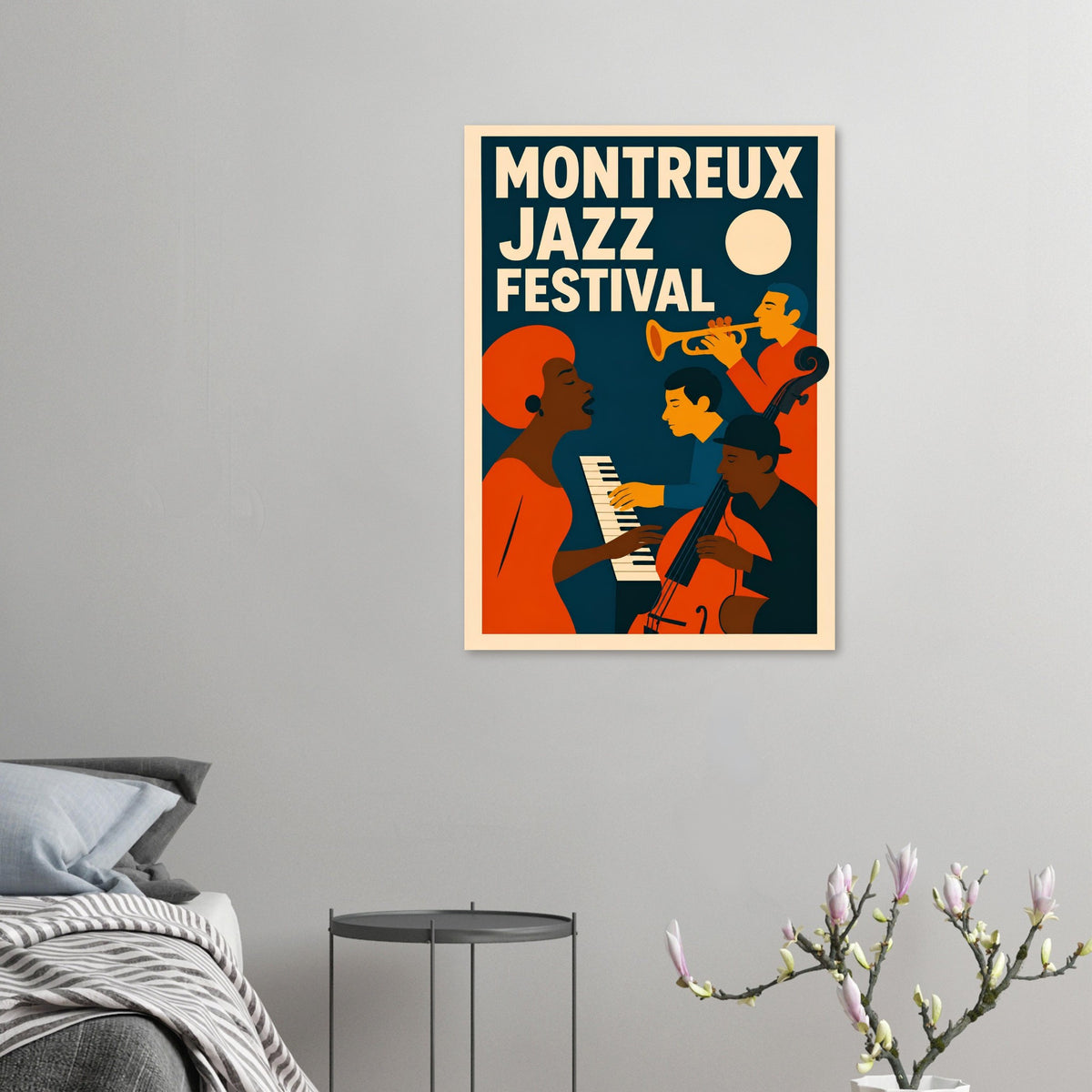 A framed vintage-style poster reading “MONTREUX JAZZ FESTIVAL” hangs on a light gray wall above a bed, with a small side table and flowering branch in the room. The poster artwork features bold orange, navy, cream, and yellow figures playing instruments.