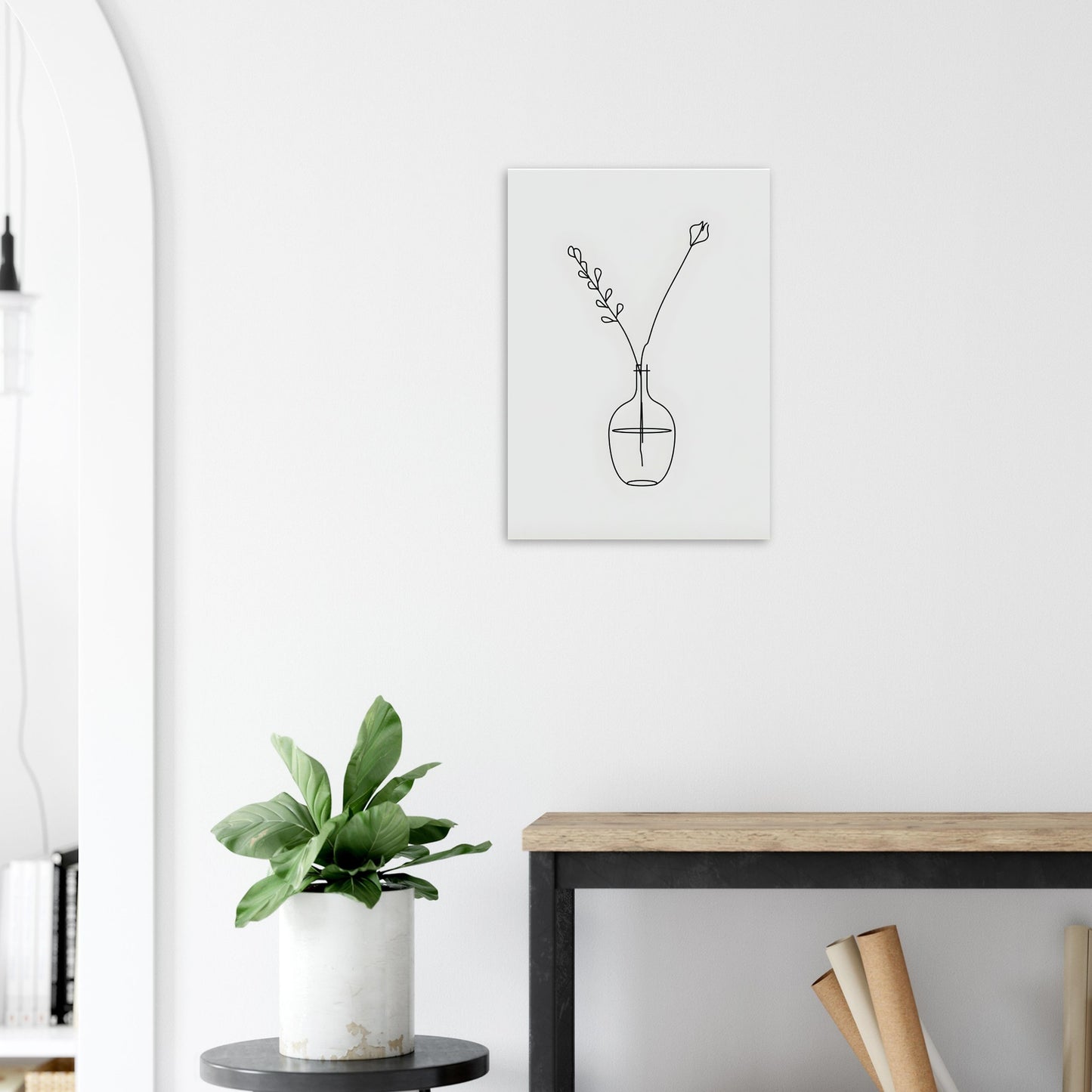 Minimalist interior with a plant, table, and wall art of a vase with flowers.
