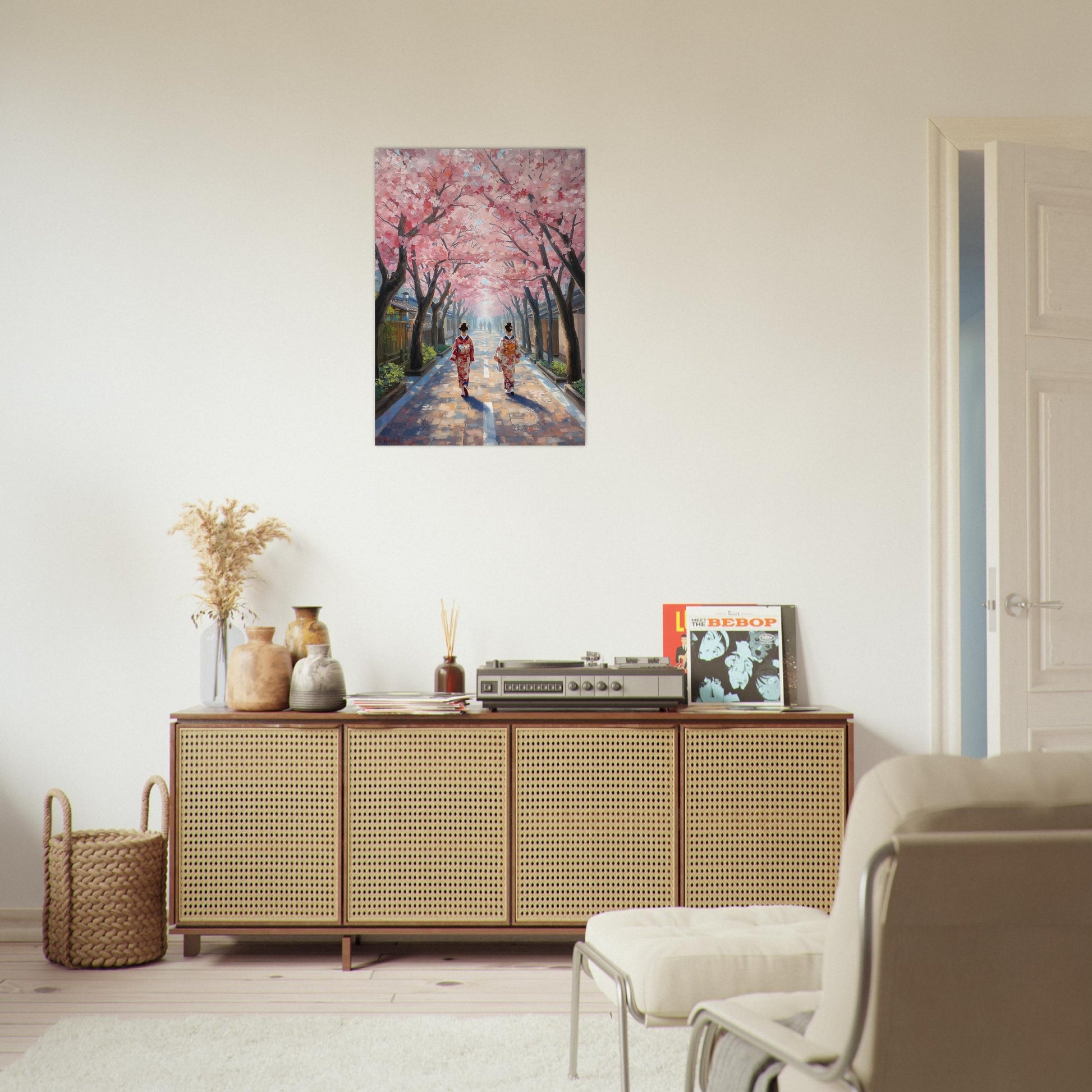 Sakura wall art displayed above a wooden cabinet in a modern minimalist interior