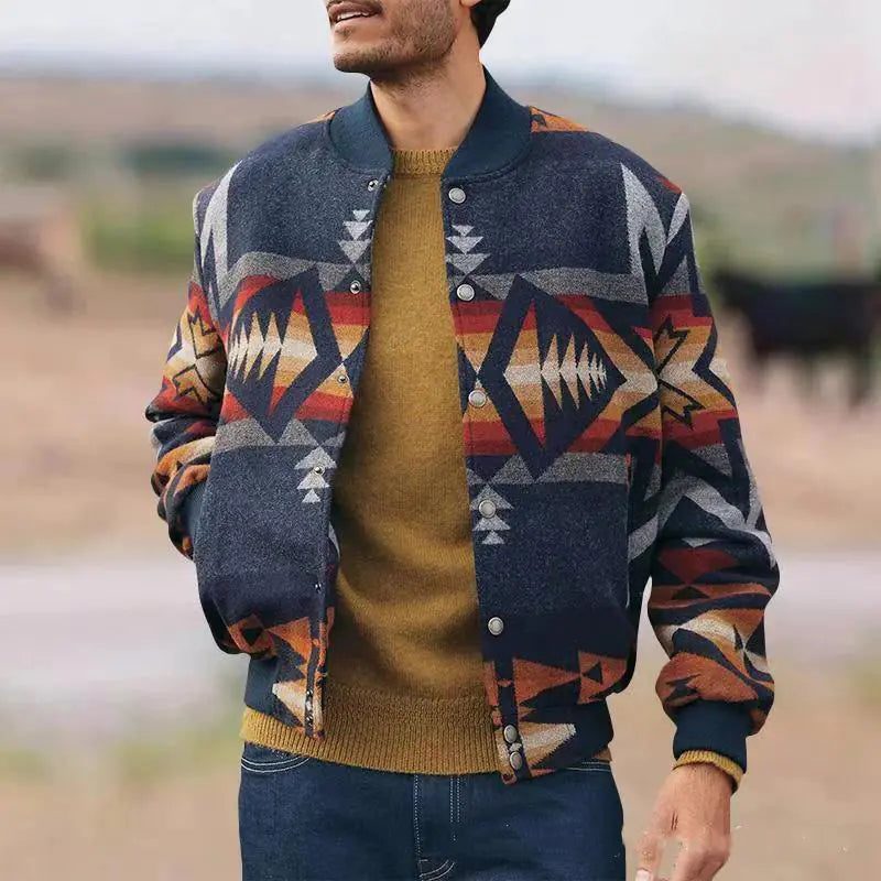 A person wearing a geometric pattern stand collar jacket with a V-neck, featuring a dark blue base with multicolored accent pattern. The jacket is paired with a yellow sweater and blue jeans.