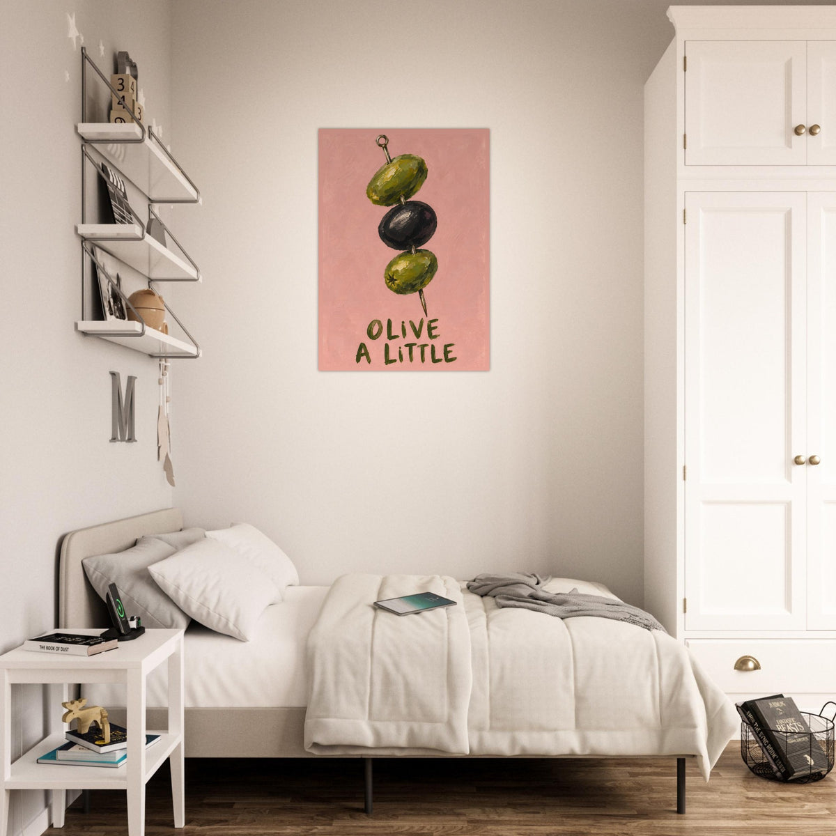 Olive a Little print above a white bed, with a leafy plant beside a bright window.