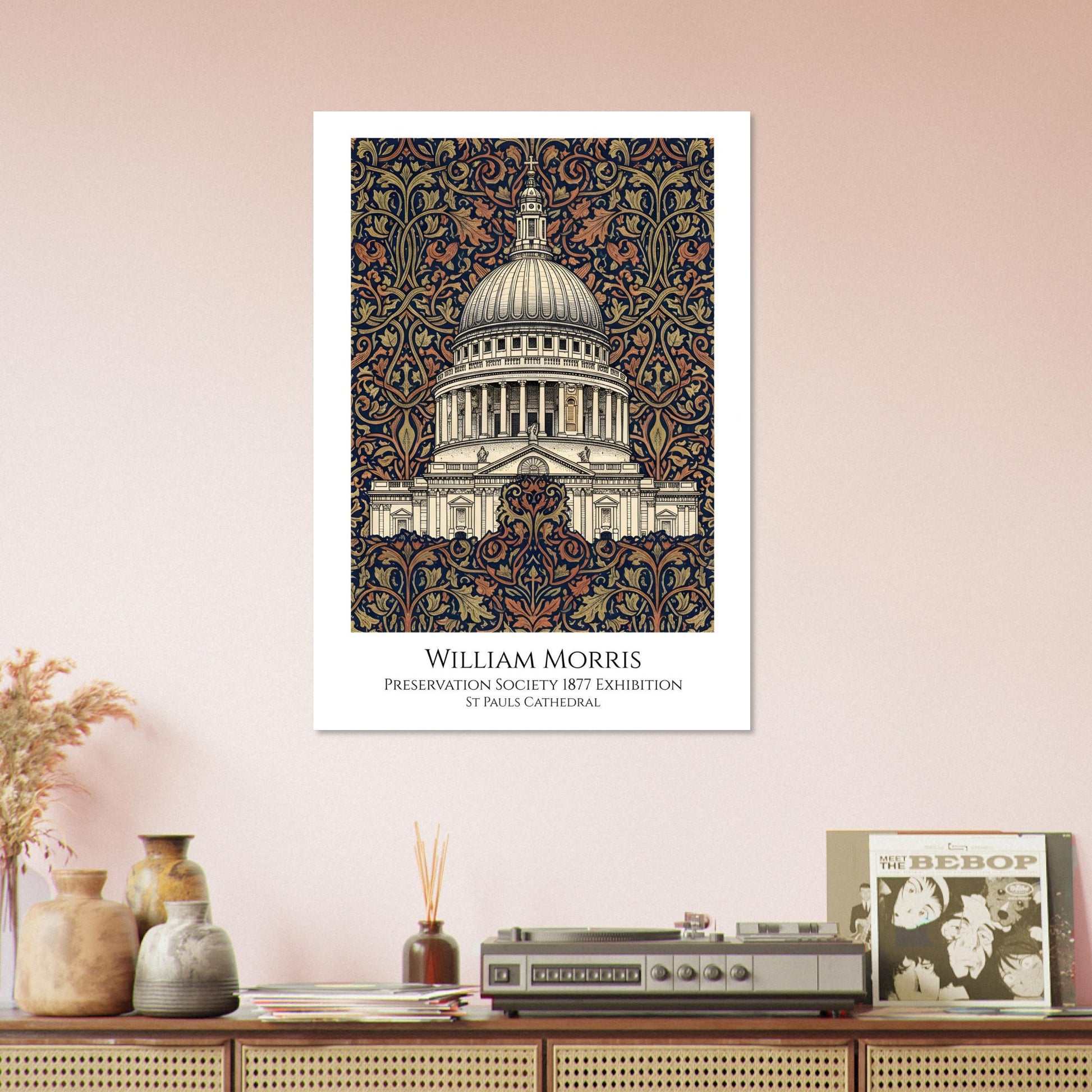 Framed artwork of St. Paul's Cathedral with decorative border on a wall above a wooden shelf.