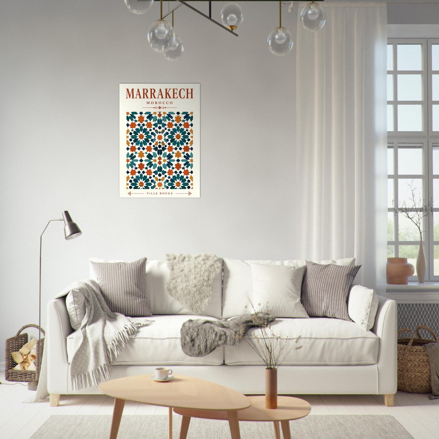 A framed art print featuring a Moroccan tile pattern with the text 'MARRAKECH' is displayed on a light gray wall above a white sofa in a modern, sunlit living room.