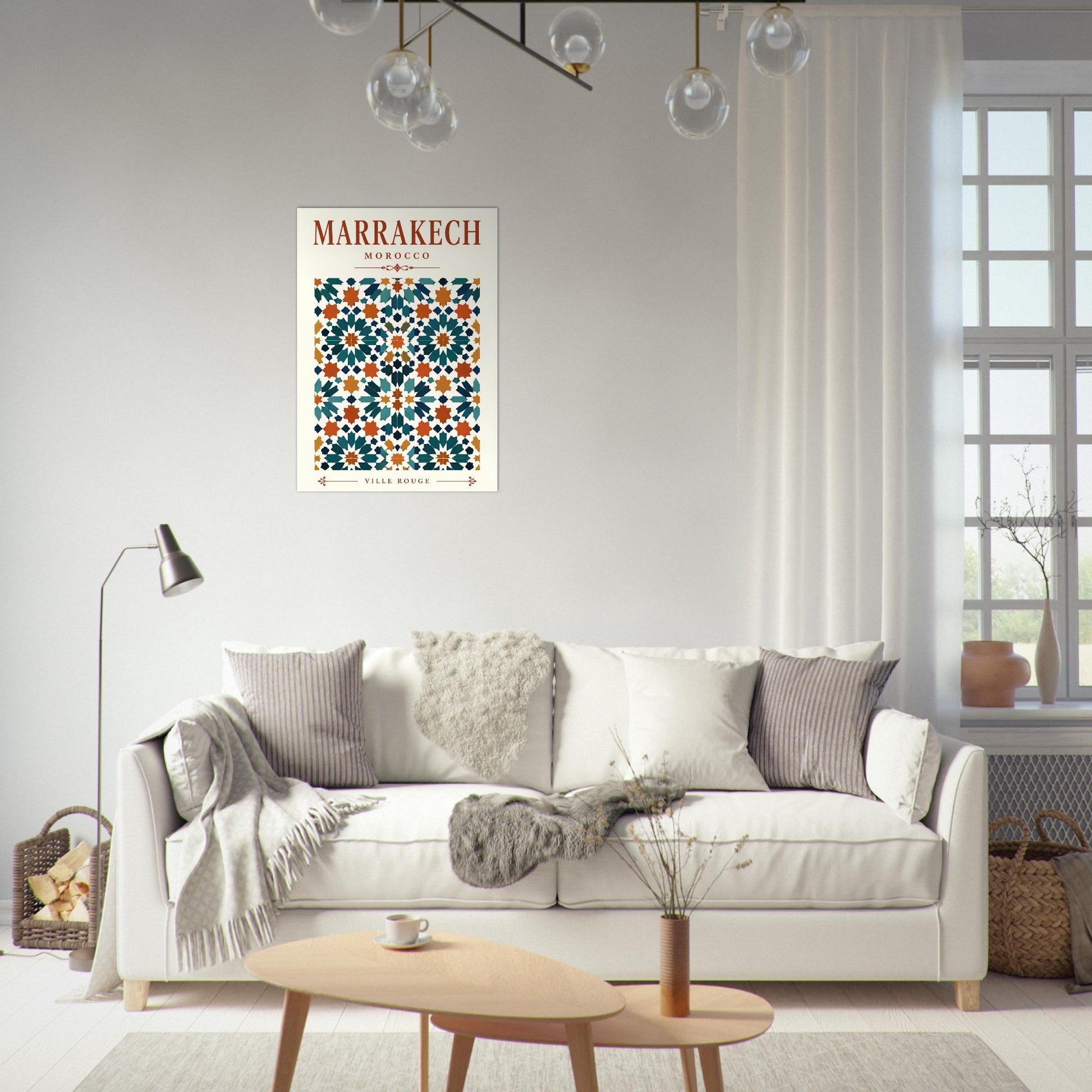 A framed art print featuring a Moroccan tile pattern with the text 'MARRAKECH' is displayed on a light gray wall above a white sofa in a modern, sunlit living room.