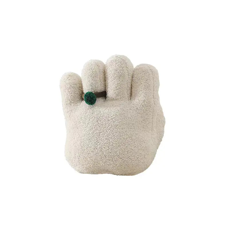 Plush toy shaped like a paw with a green button on a white background