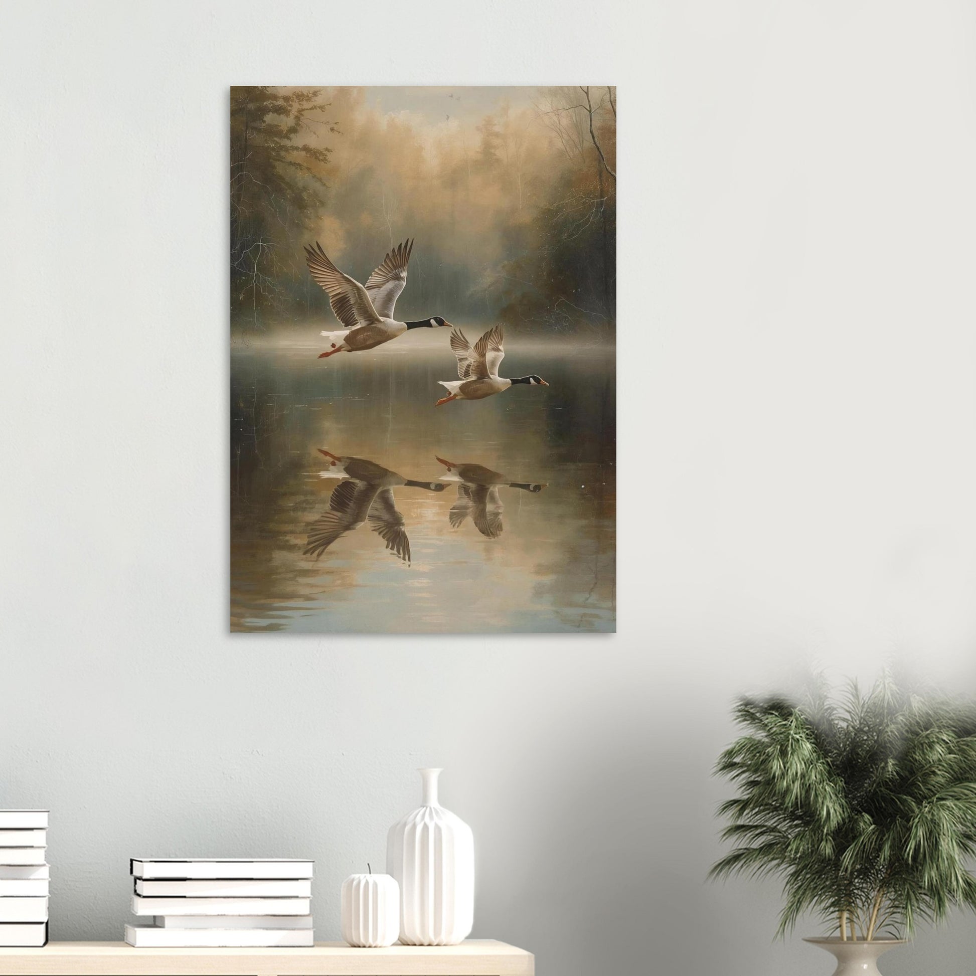 Canvas print of flying geese over water on a wall above a shelf with decorative items.