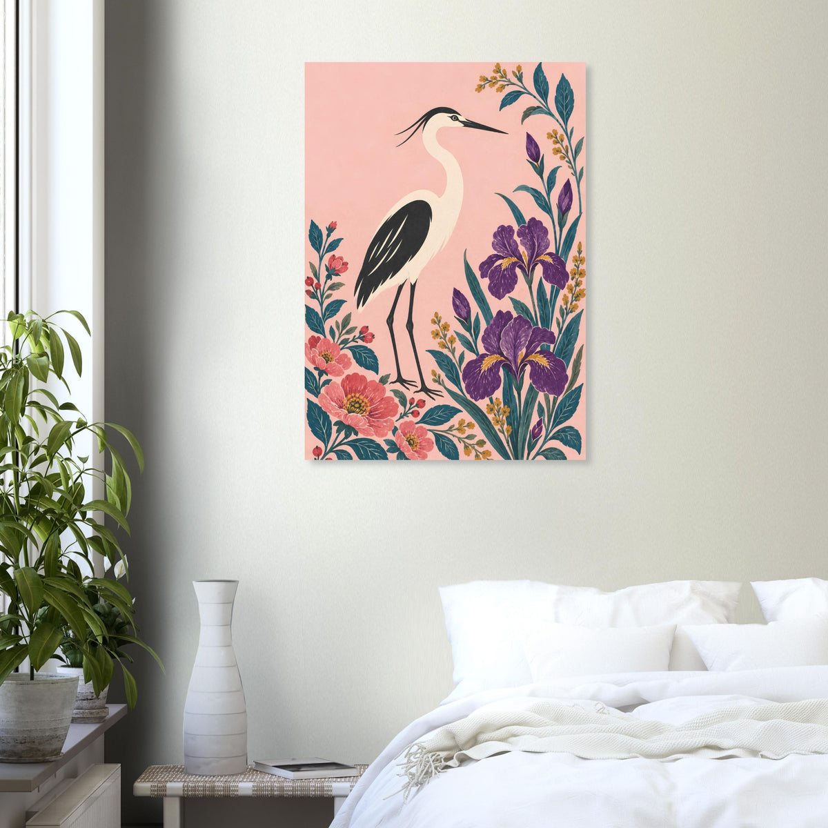 A vertical wall art print featuring a heron bird and colorful flowers, displayed on a light gray wall above a bed in a styled bedroom setting.