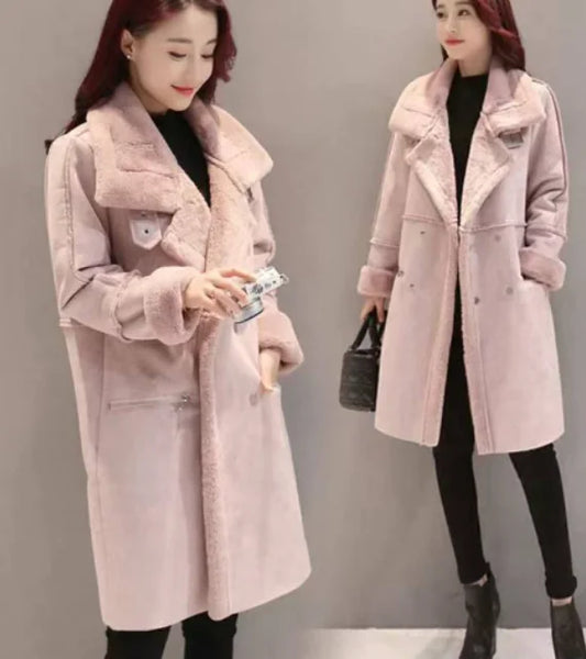 Woman wearing a long pink coat with fur trim, holding a water bottle and a black handbag.
