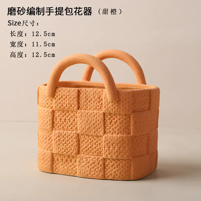 Orange textured handbag with handles on a beige background