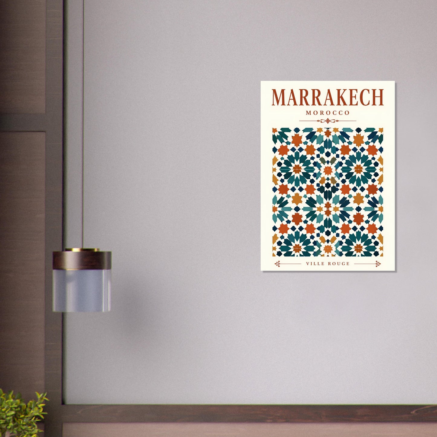 A vertical art print poster featuring a Moroccan tile pattern with the text 'MARRAKECH MOROCCO' and 'WELLER MUGUE' at the bottom, displayed on a light gray wall next to a modern wall lamp.